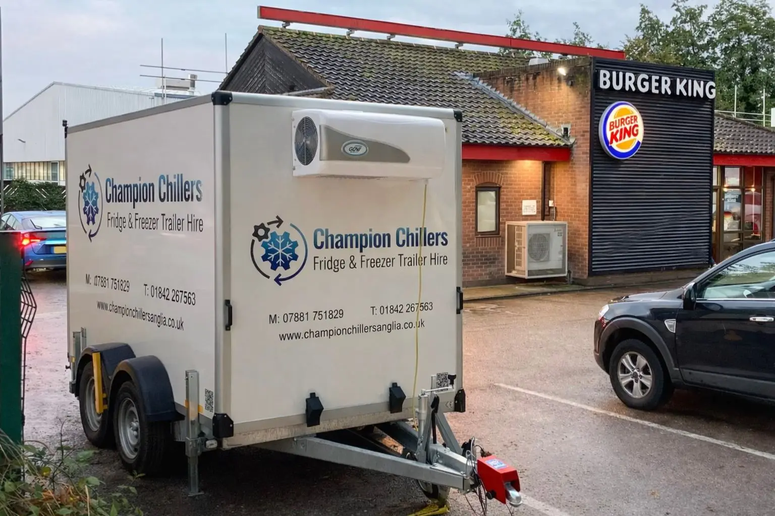 Champion Chillers fridge and freezer trailer hire unit parked outside a Burger King for commercial refrigeration cover.