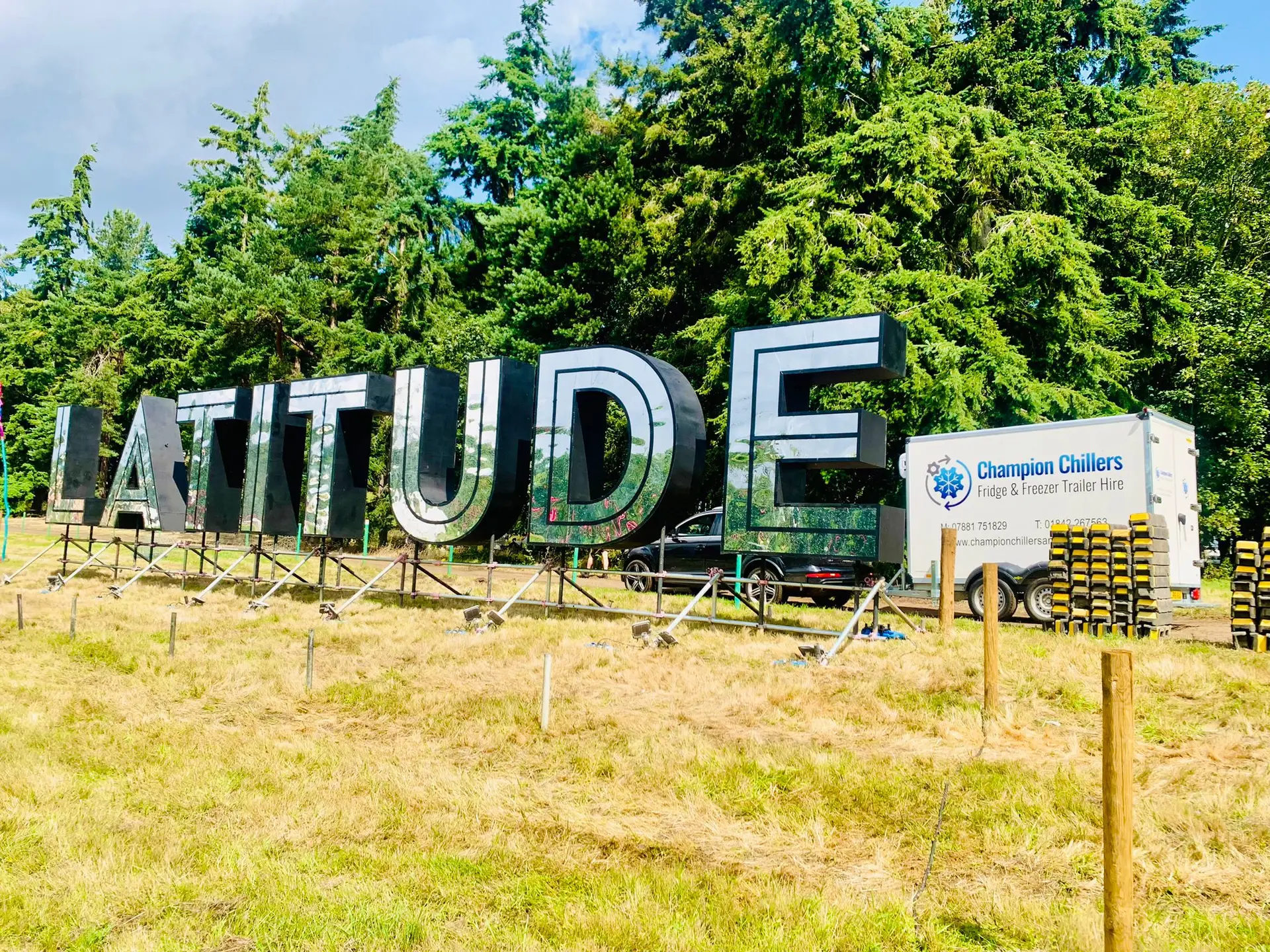 Champion Chillers fridge and freezer trailer hire unit parked beside the Latitude Festival sign.