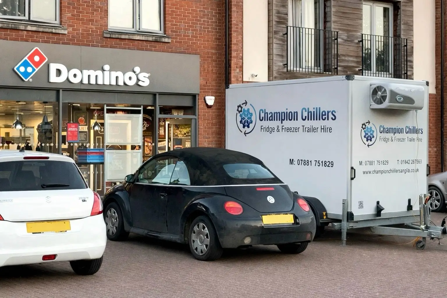 Champion Chillers fridge and freezer trailer hire unit parked outside a Domino's for commercial refrigeration cover.