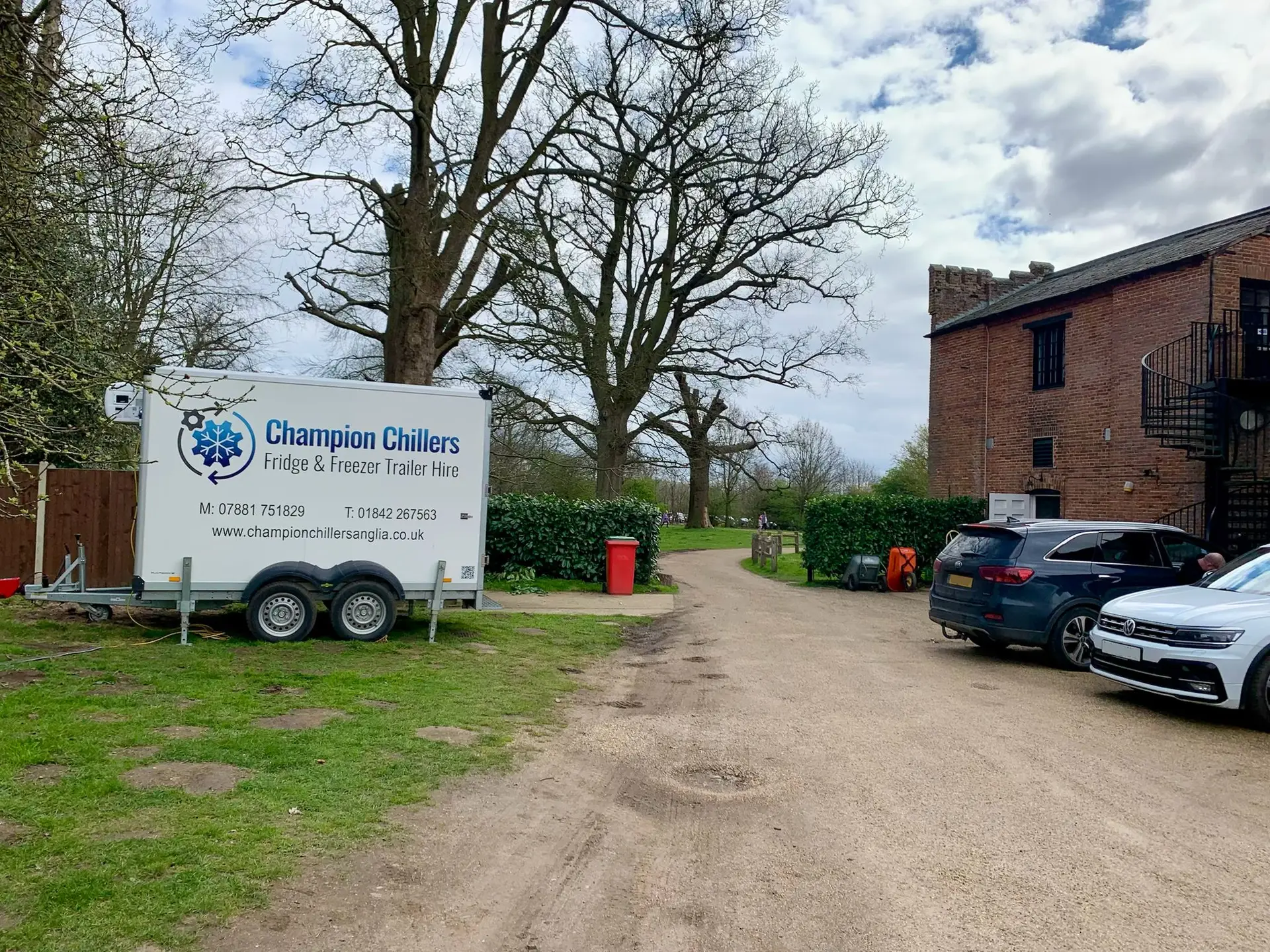 Champion Chillers fridge and freezer trailer hire unit parked on a gravel driveway at a country estate.